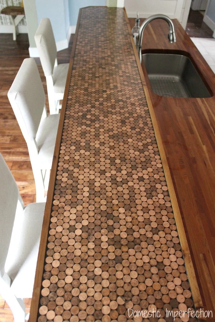 Handmade penny countertop, with a durable epoxy sealant and a wood edge