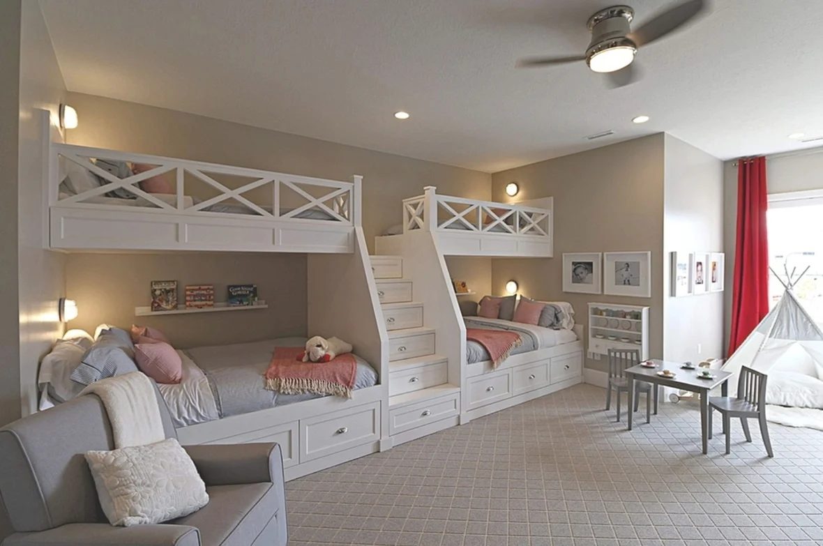 Built In Bunkbeds, White With Grey Bedding And Pink Blankets Qand Pillows With Stairs In The Middle Of The Four Bunkbeds