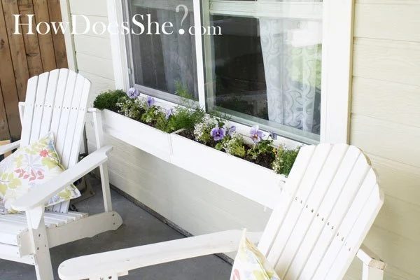 White Window Boxes With White Chairs And Pastel Floral Spring Pillows