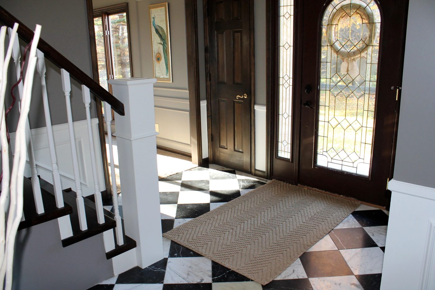 entry with checkered tile and curved staircase remodel - Construction2Style via @Bekob