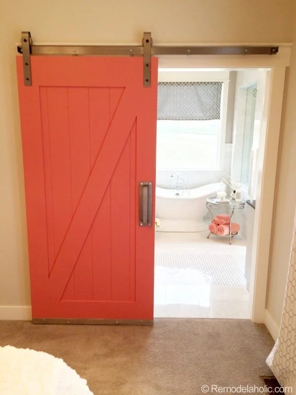 Coral Sliding Barn Door With Bathroom Peek, Coral Towes And Metal Side Table To Tub