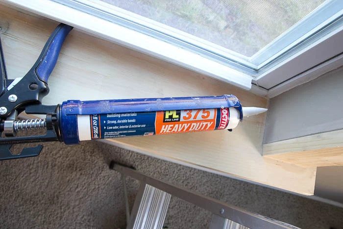 Caulking after installing Handmade window trim featured on Bekob.com