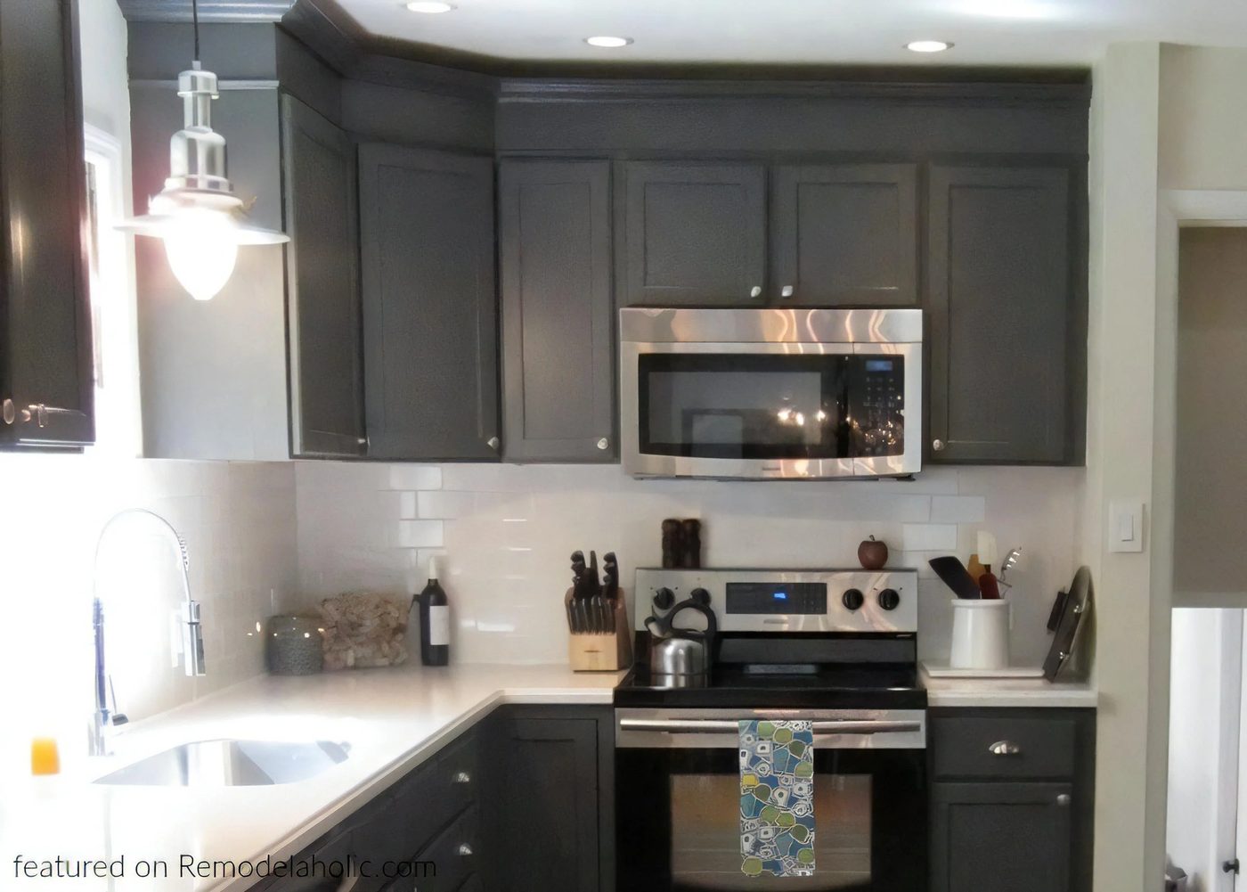 Updated Kitchen Renovation With Charcoal Dark Gray Kitchen Cabinets In Peppercorn White Countertops And Stainless Steel Appliances Featured On Bekob 022333