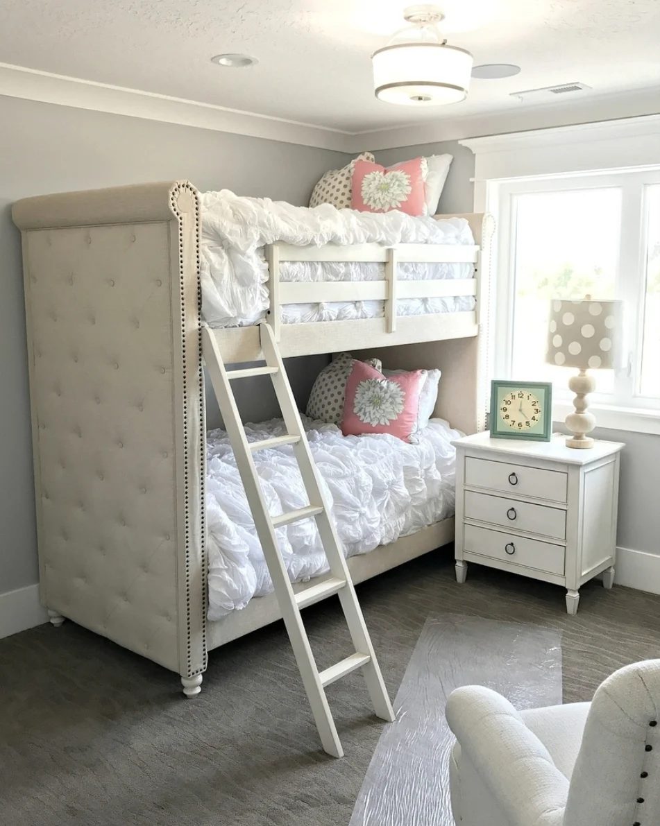 Plush Bunk Beds With vivid Tufted White Bedspreads And Pink Floral And Polka Dot Pillows