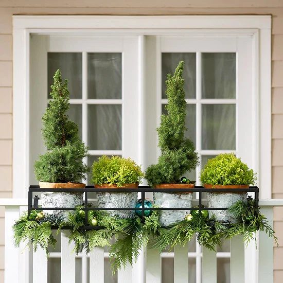 mini Christmas trees in outdoor planter window boxes - BHG via @Bekob