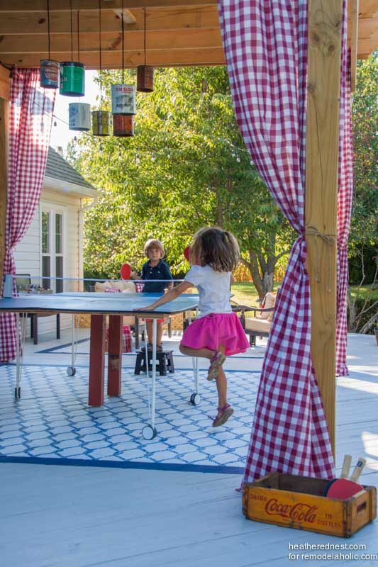 well fitted for summer! A Handmade pergola on a deck, with a painted rug and curtains. Build it with the walkthrough from The Heathered Nest on Bekob.com