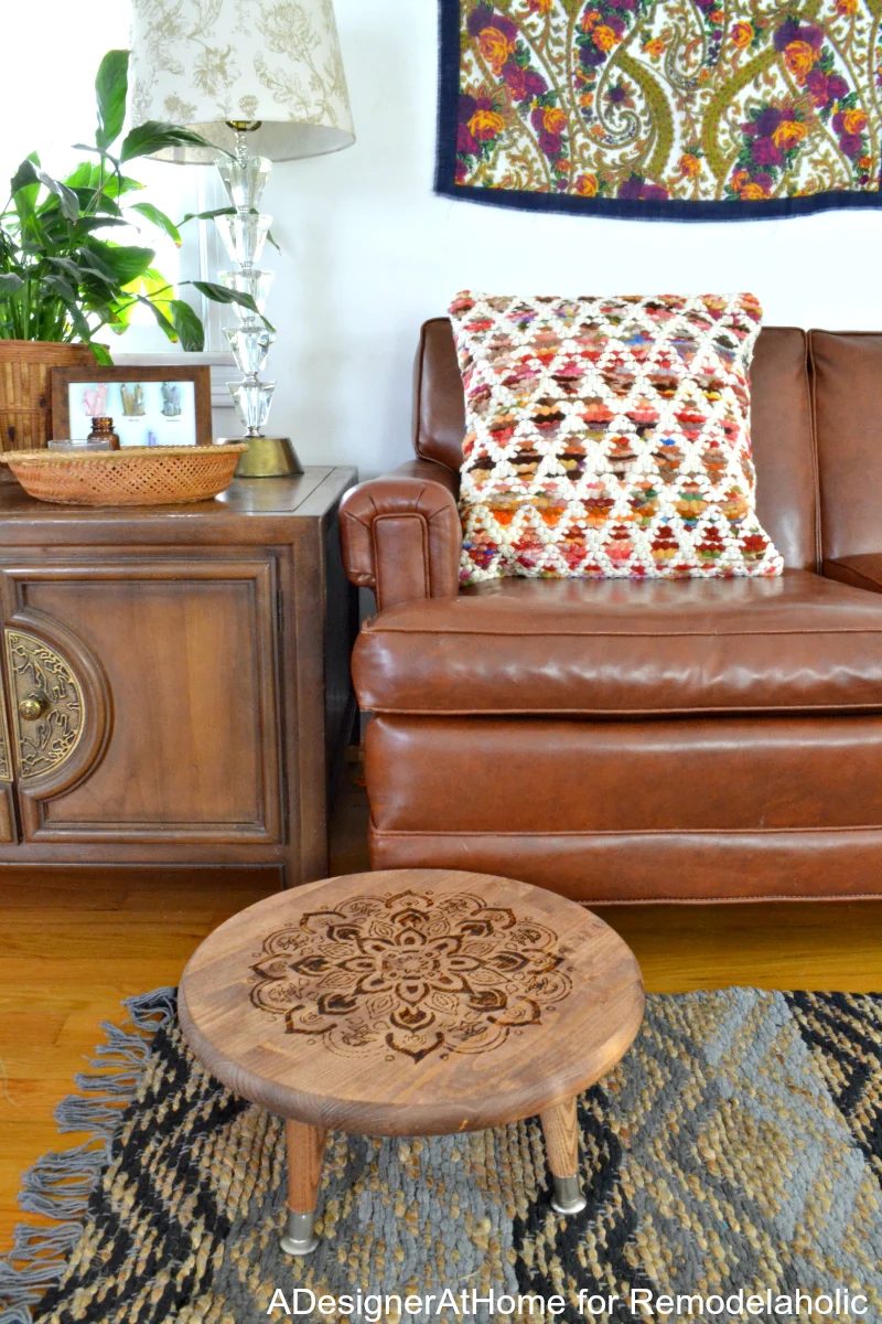 This straightforward wood-burned planter stool (or footrest) is a great addition to a color boho style living room