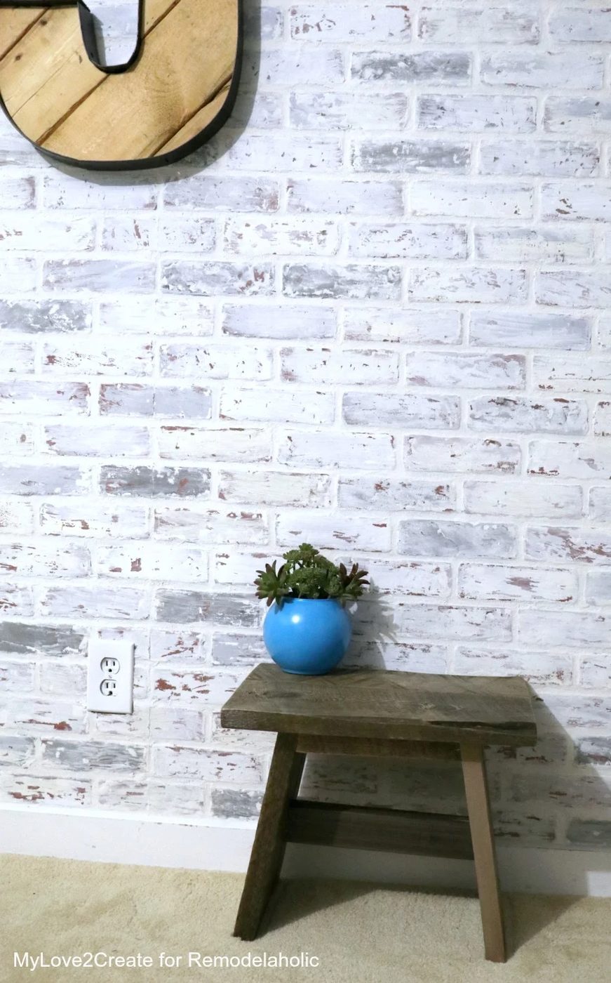 Handmade wood step stool in a teen room with faux brick wall and pallet wood letters