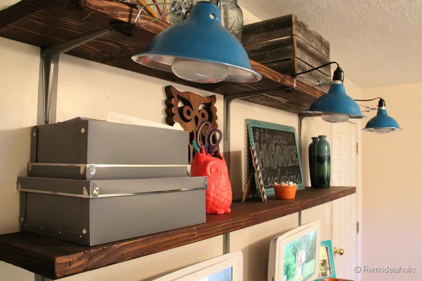 Wood Wall Shelves With Metal Brackets And Blue Light Fixtures