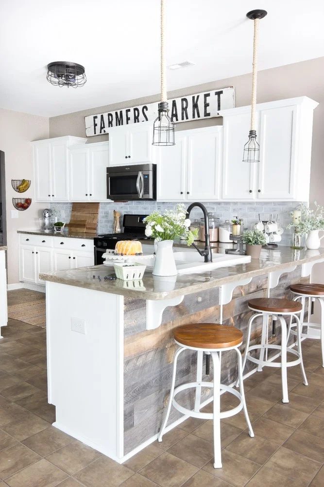 Handmade Farmers Market Sign In Kitchen With White Cabinets And Barstools And Natural Wood Shiplap On Bar