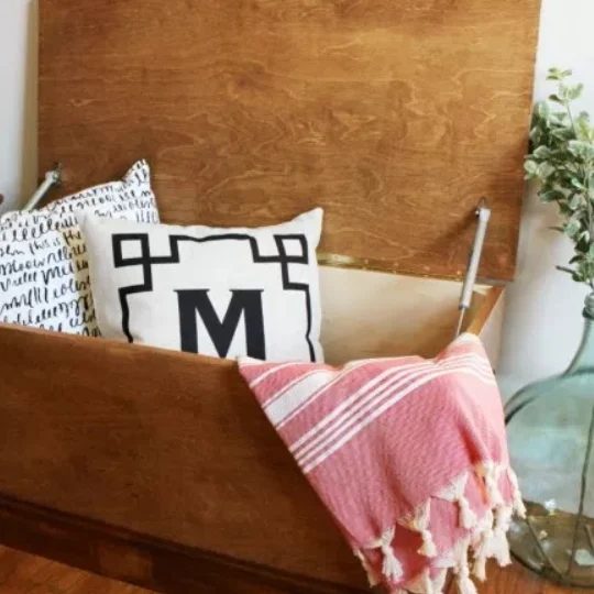 direct Handmade Wooden Storage Chest Plans walkthrough With Pillows And Blanket Hanging Out Of Open Top