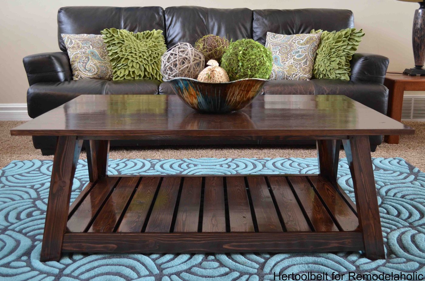 Inspired by a coffee table in a HGTV dream home. I love the trapezoid base and slats that make up this table. Handmade slat coffee table with free plans.