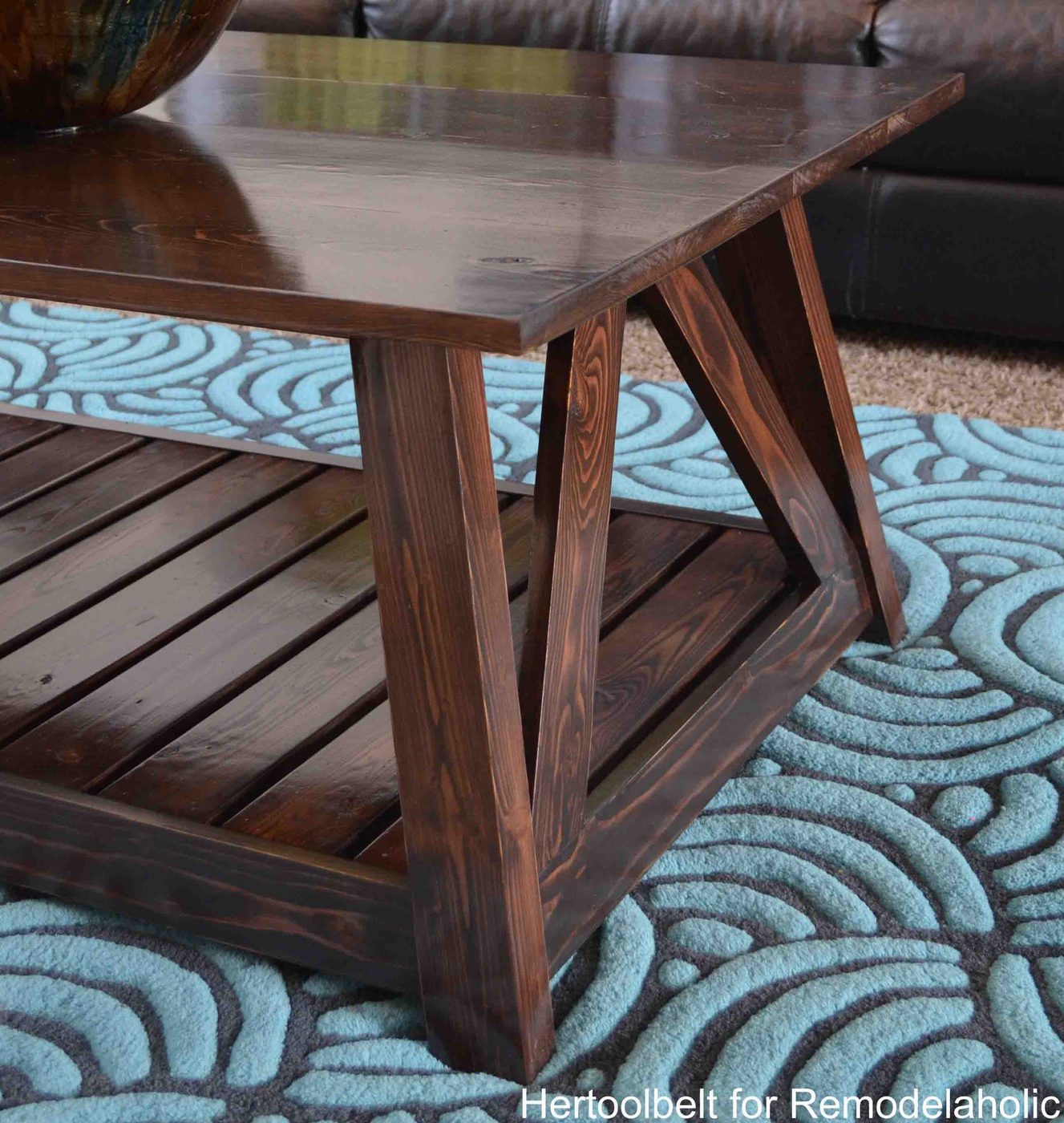 Inspired by a coffee table in a HGTV dream home. I love the trapezoid base and slats that make up this table. Handmade slat coffee table with free plans.