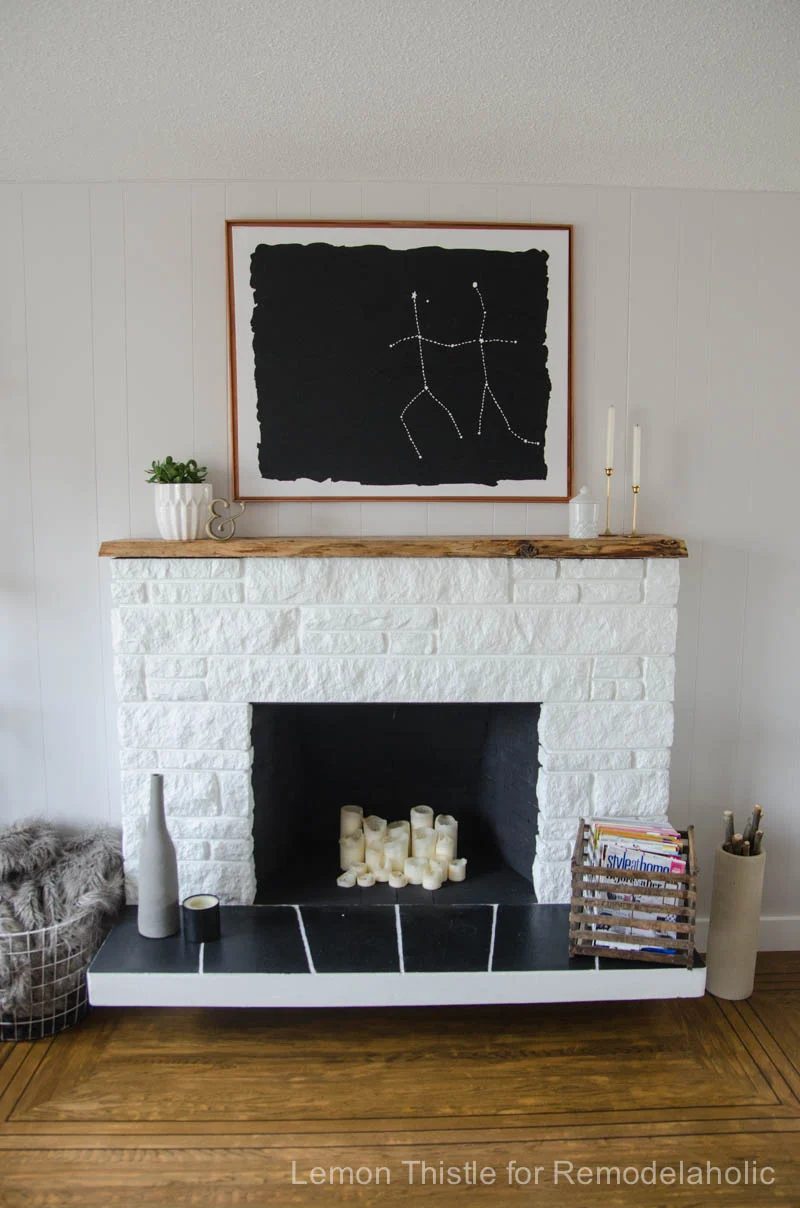 Updated stone fireplace with a handmade live edge wood mantel. striking!