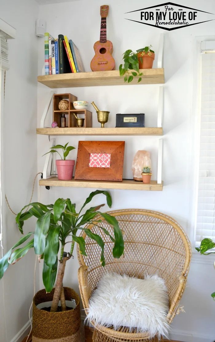 Taking an unusued corner and making it a place to display decor and house an additional seat for the living room