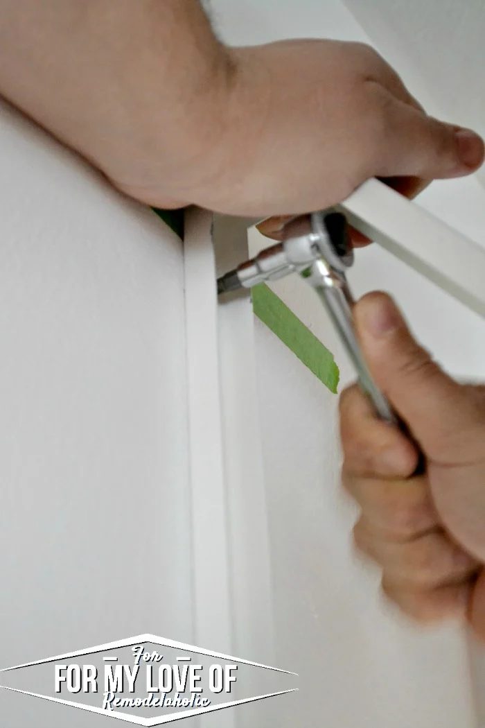 use a socket wrench and phillips head bit to tighten the screws into place through the bracket