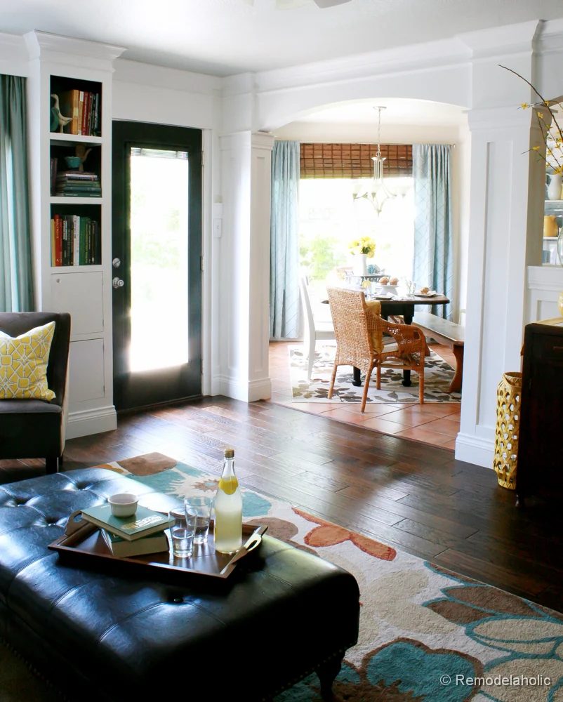 Living Room Remodel with yellow accents wood floors and built-in bookcases and columns with arches-35