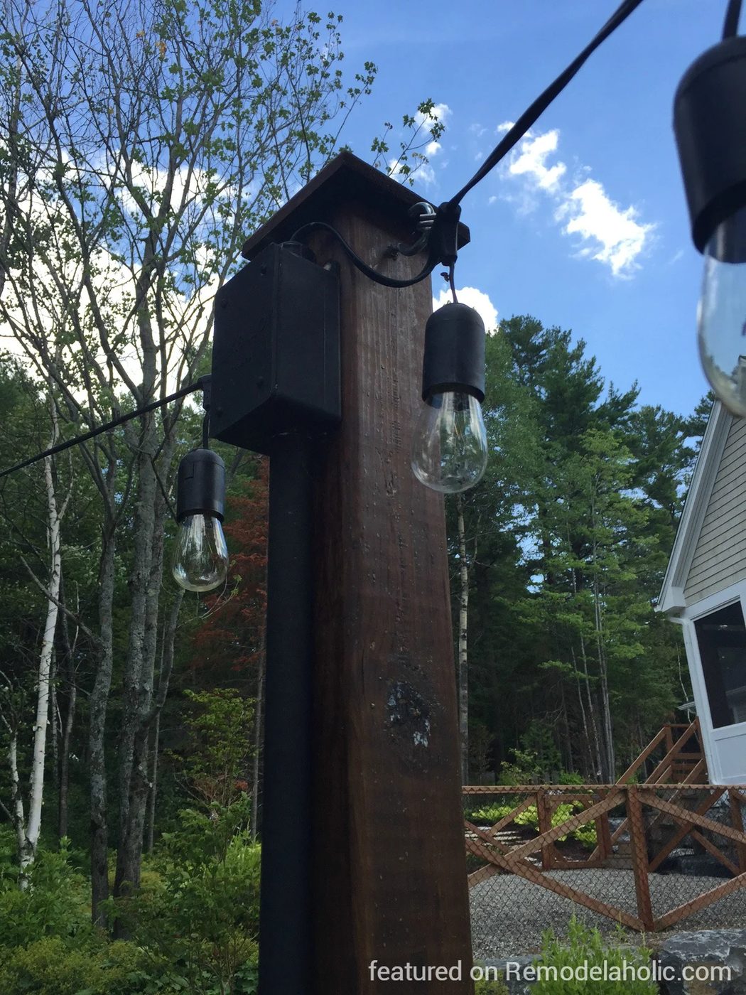 how to hang string lights on posts around a fire pit, featured on @Bekob wm