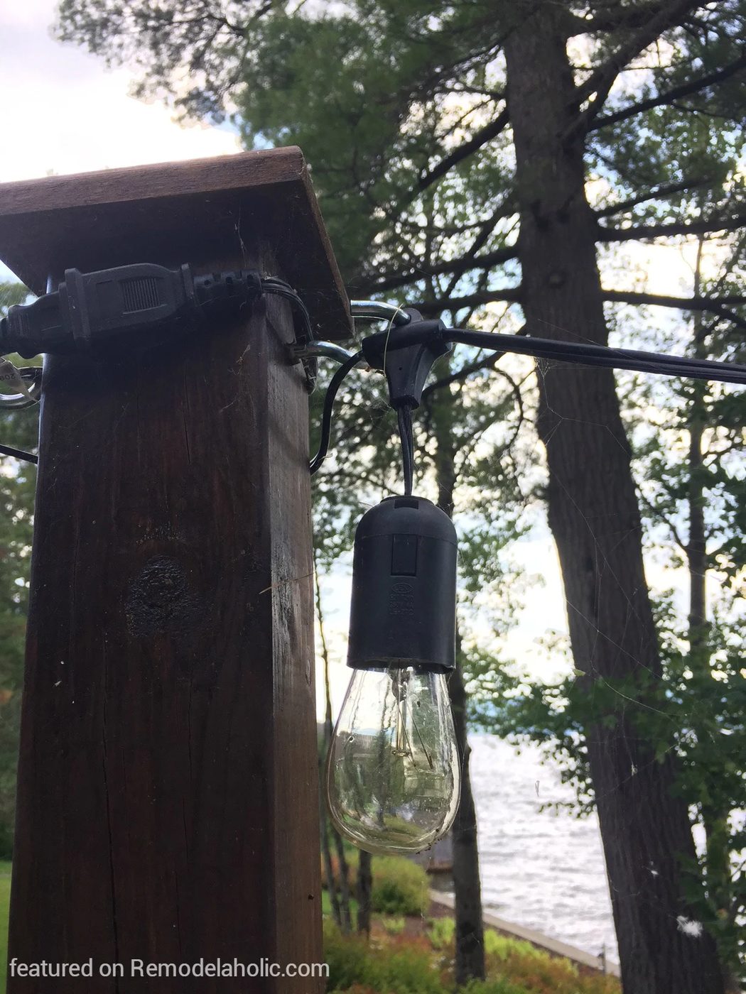 straightforward Handmade method how to hang string lights on posts around a fire pit, featured on @Bekob wm