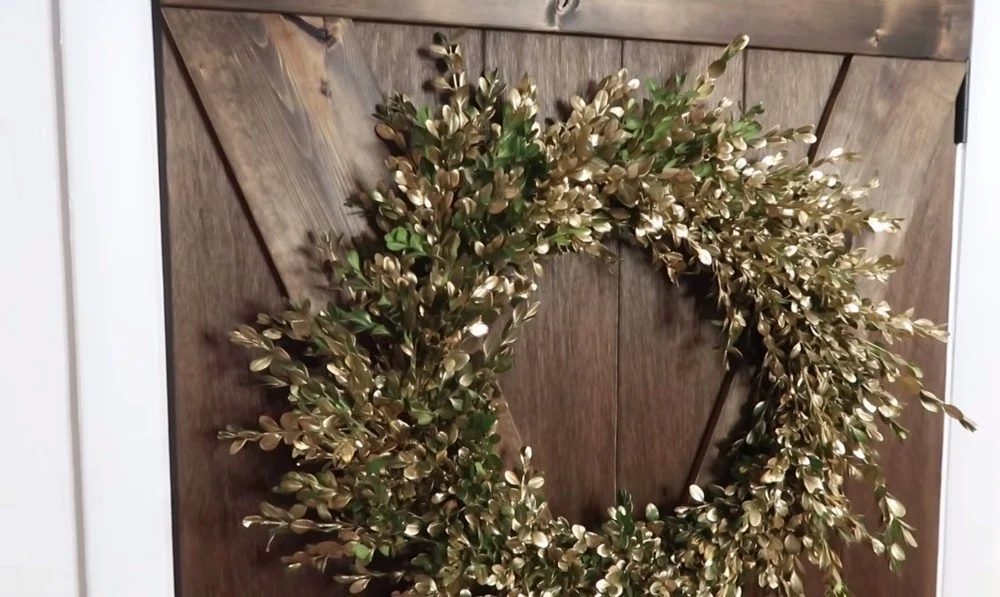 Handmade Fresh Boxwood Wreath With Gold Accents On Brown Stained Barn Door