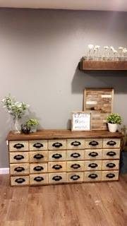 Medium Brown Colored Wooden Table With Light Brown Stained Rectangular Drawers Filling Entire Unit