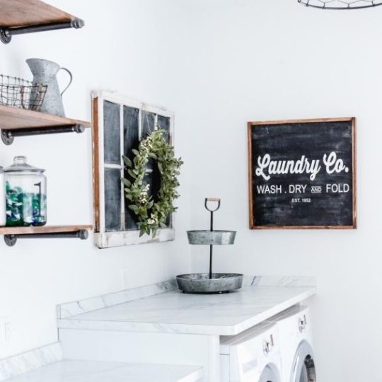 Laundry Room With White Walls, Wooden Shelves, Faux Window And Laundry Co Chalkboard Sign
