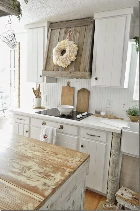 Farmhouse Kitchen Inspiration -- love the reclaimed wood range hood and the newel post by the sink