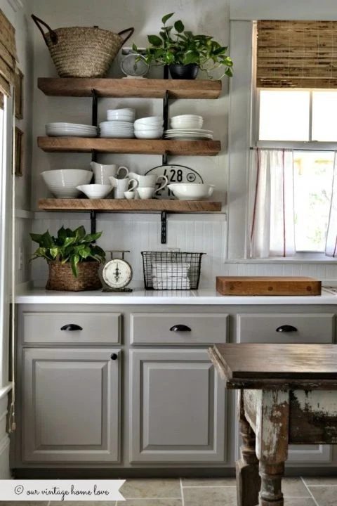 Farmhouse Kitchen Inspiration -- the combo of the wood shelves and natural bamboo shades with the white countertops and gray cabinets is well fitted