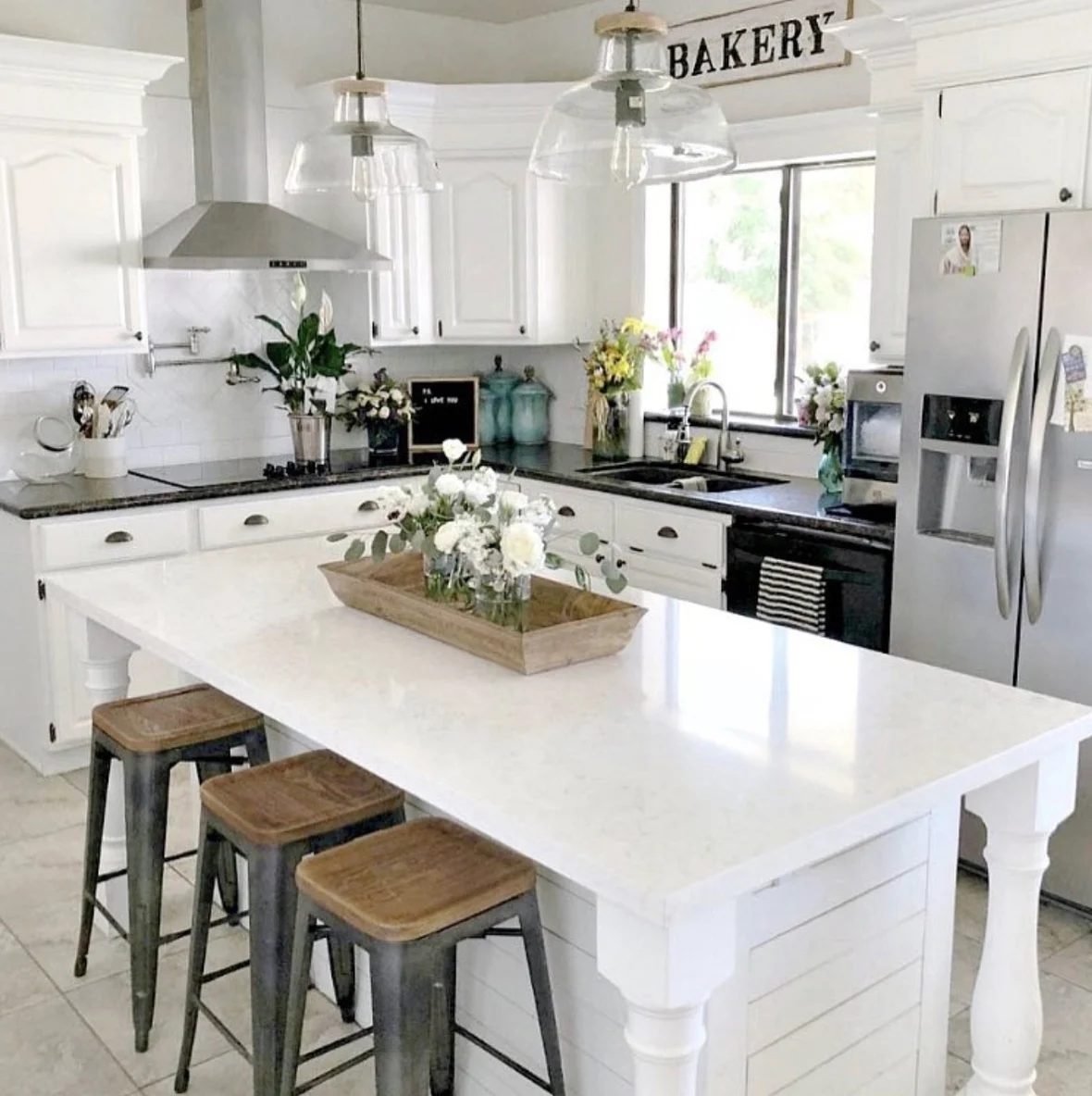 Farmhouse Kitchen With White Island, Counters, And Wall And Natural Wood Accents