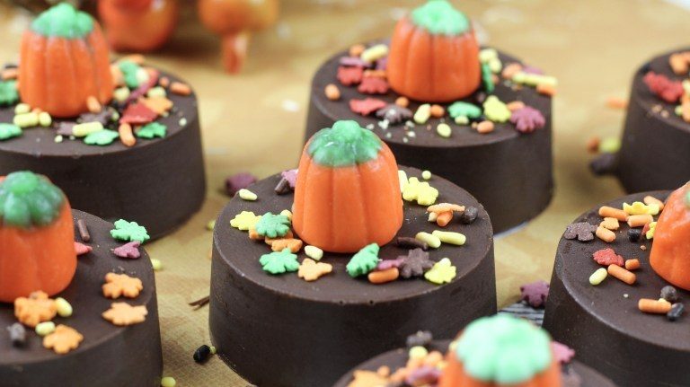 Chocolate Dipped Oreos With Fall Leaf Sprinkles And Candy Pumpkin On Top