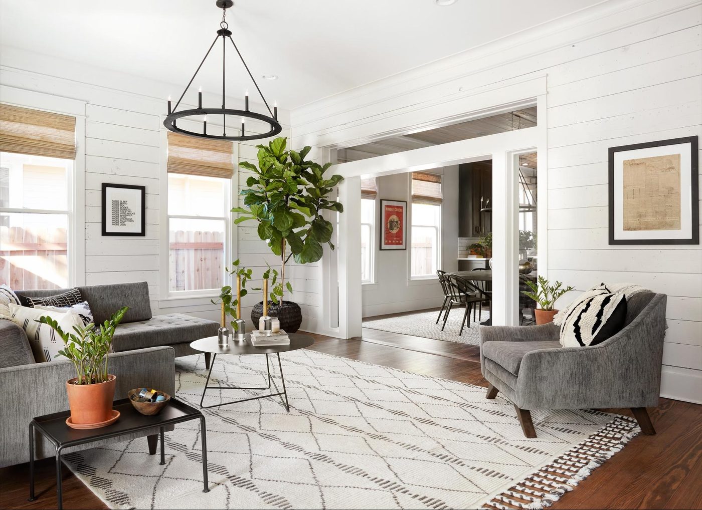 Get This Look: Fixer Upper Living Room from The Americana House | Recreate the iconic Joanna Gaines modern farmhouse chic style from the shiplap and neutral area rug to the chandel