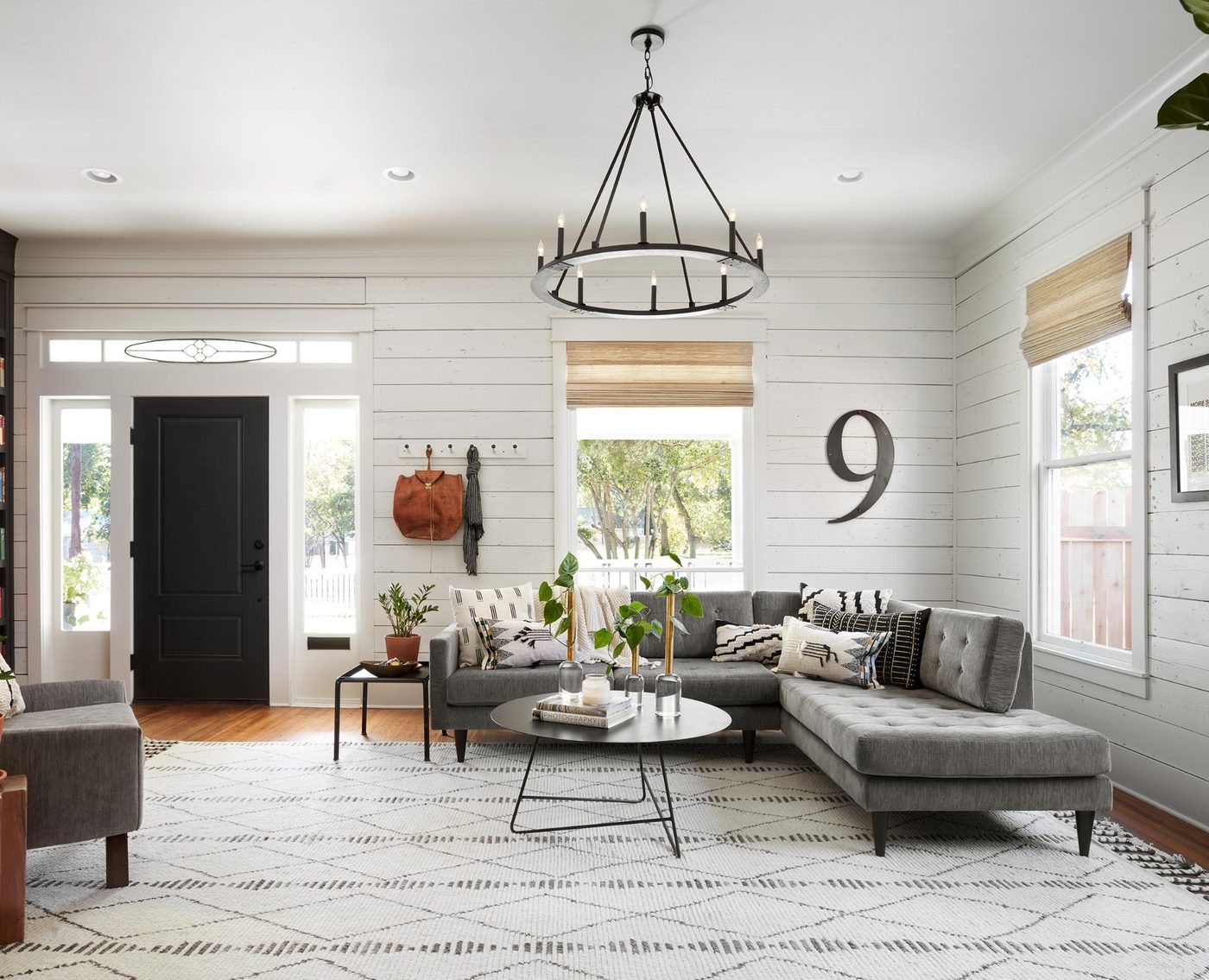 Get This Look: Fixer Upper Living Room from The Americana House | Recreate the iconic Joanna Gaines modern farmhouse chic style from the shiplap and neutral area rug to the chandel