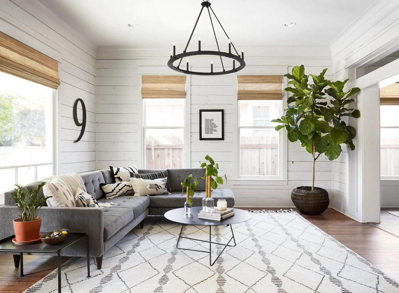 Get This Look: Fixer Upper Living Room from The Americana House | Recreate the iconic Joanna Gaines modern farmhouse chic style from the shiplap and neutral area rug to the chandel