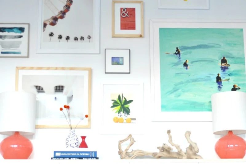 Gallery Wall Full Of Frames Of Every Color And Size With Two Coral Lamps On A Shelf In Front, Images In Frames Art Of Every Color