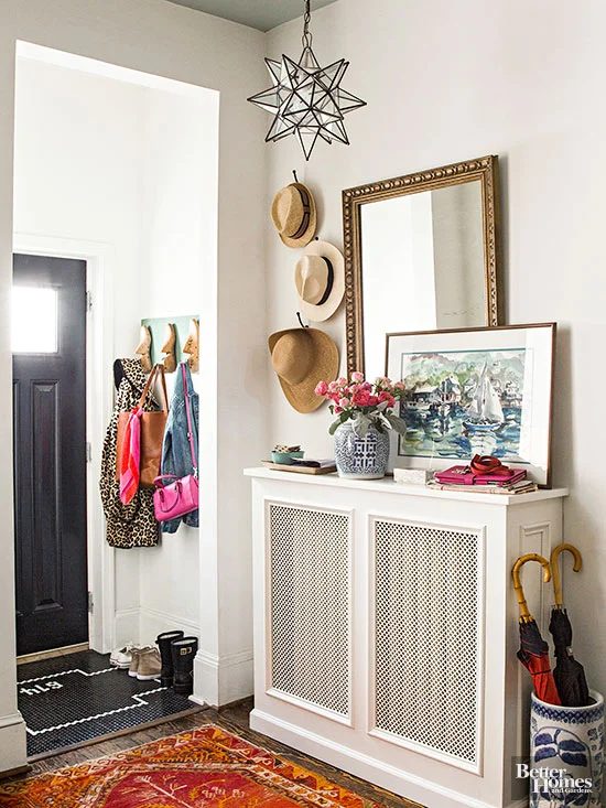 entryway with console table built around a radiator, via BHG