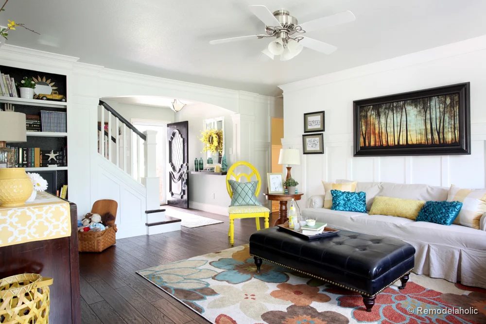 Living Room Remodel with yellow accents wood floors and built-in bookcases and columns with arches