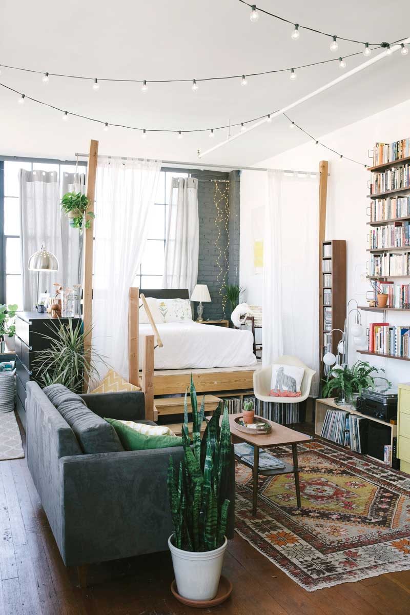 use a string of bistro lights in a living room via Design Sponge