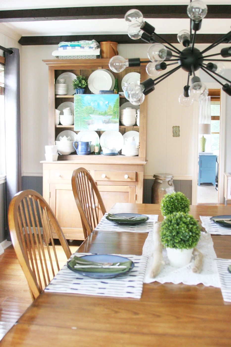 hang an art canvas on the front of a china cabinet shelf for decor, summer decor options at Craftivity Designs