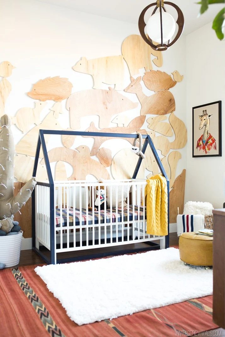 baby boy nursery with IKEA method crib and wooden animals on the wall Vintage Revivals