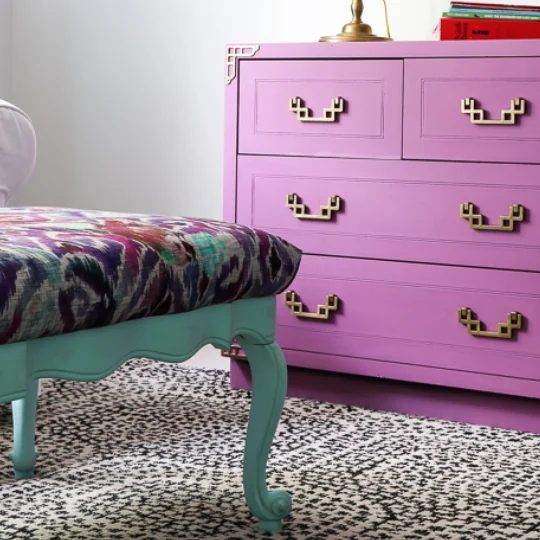Coffee Table Upcycled To A Upholstered Bench, Colorful Paint, Bench Has Green Legs, Dresser In Background Has Purple Paint And Gold Handles