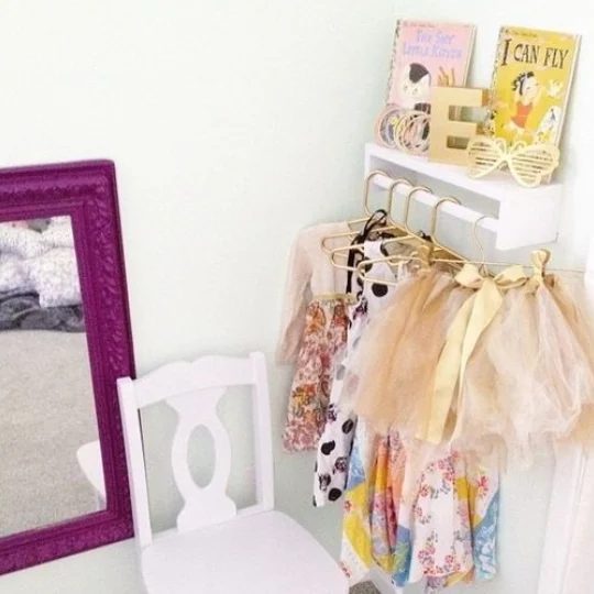 Hacks For A Perfectplayroom, Pictures Shows Dress Up Corner With Hanging Costumes, Mirror, Chair, Shelf With Books And Gold Sunglasses And Letter E