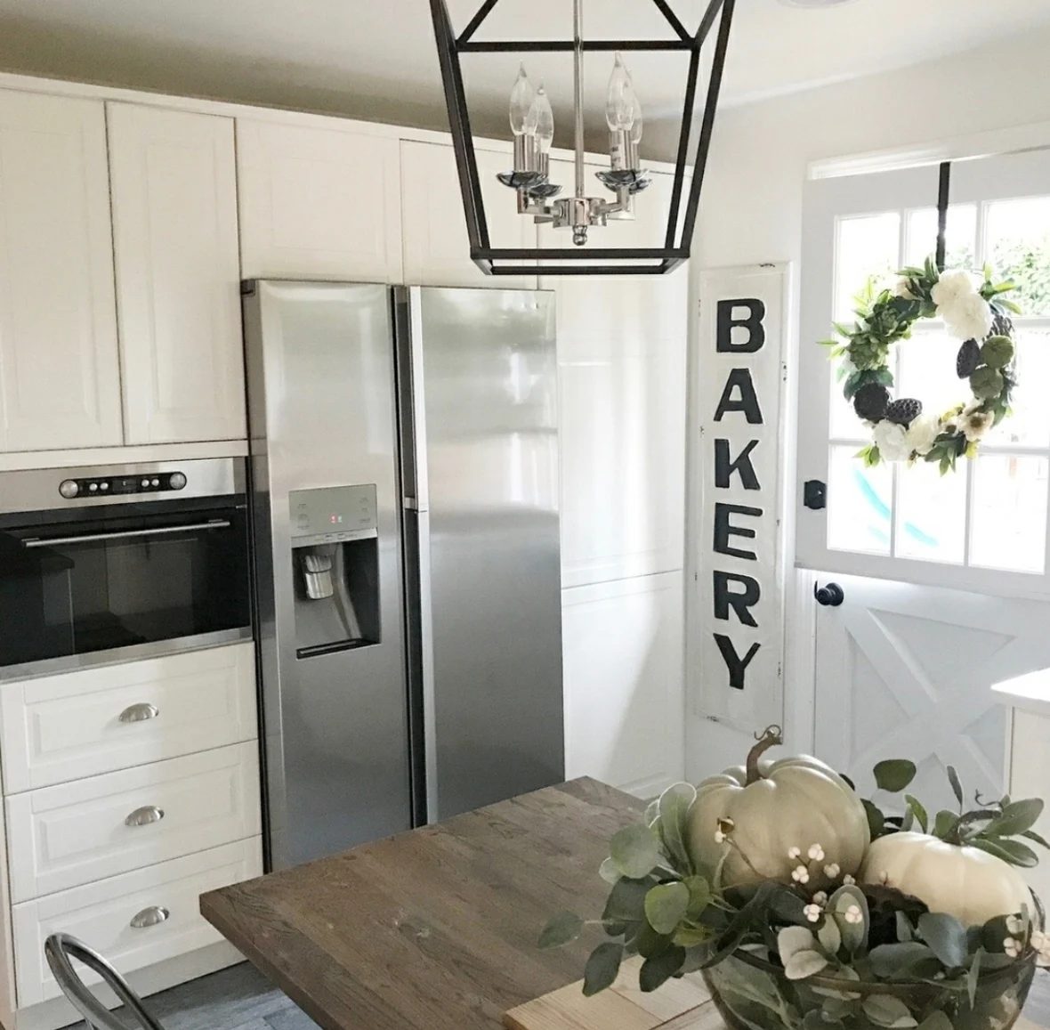 Farmhouse Kitchen In The Fall White With Green Leaves And Pumpkins And Flowers
