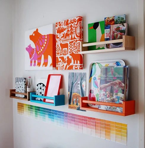functional wall decor -- IKEA spice racks as part of a wall collection to hold books and decor