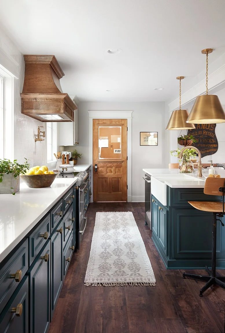 Fixer Upper Plain Jane House Kitchen. Love the white cabinets with the peacock blue island and gold pendants. Get This Look: Fixer Upper Plain Jane House Kitchen images via Magnoli
