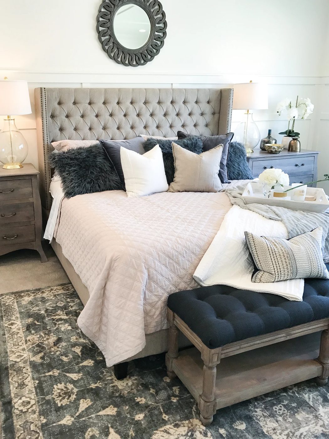 Cozy Luxe Bedroom with tufted headboard, white walls and shiplap ceiling.