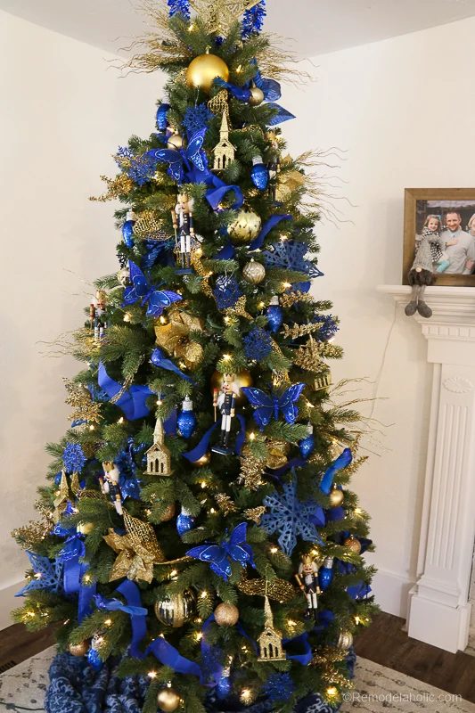 Save money by decorating your Christmas with an affordable Dollar Tree haul! This is our third dollar store Christmas tree, and this gold and blue tree decor also features some of 