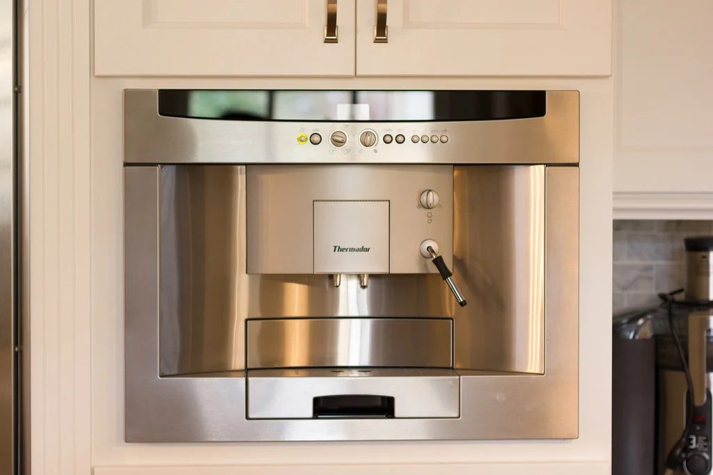 built-in espresso machine in a white kitchen renovation on Bekob