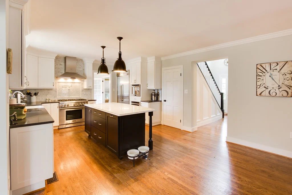 industrial brass lighting with marble island in a white kitchen on Bekob