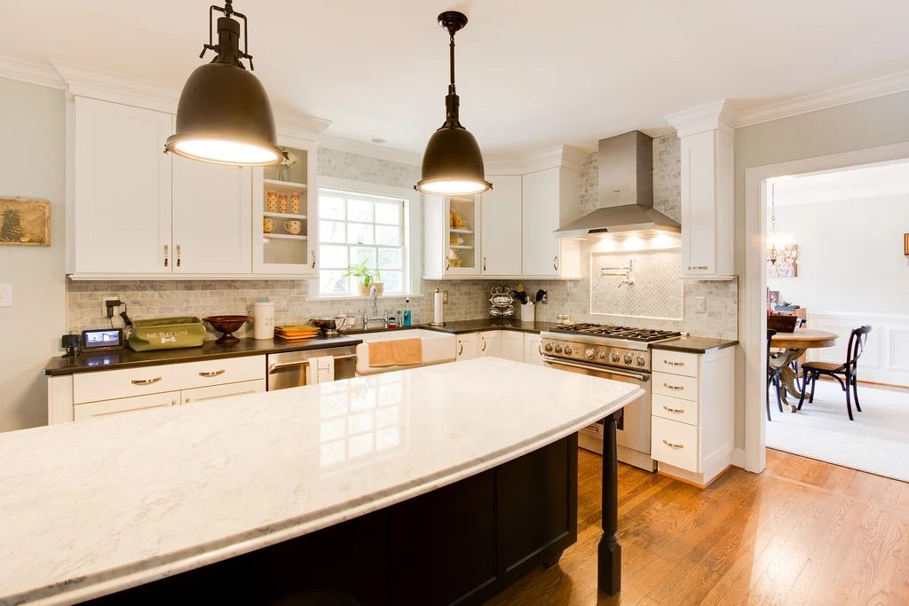 white kitchen renovation with brass industrial lighting and marble on Bekob