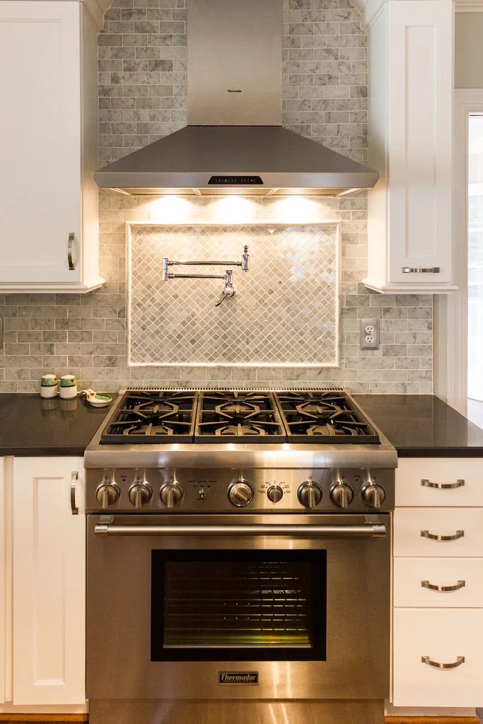 white kitchen with marble subway tile and tile backsplash over stove on Bekob